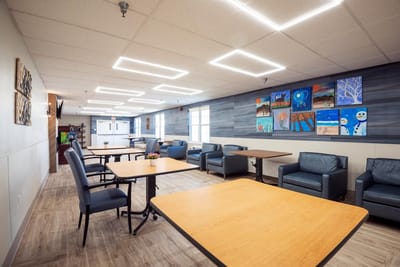 A bright common area with seating and artwork
