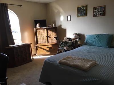Cozy private room with a bed and storage furniture