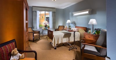 Brightly lit resident room with comfortable furniture