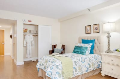 Brightly decorated resident room with bed and cozy furnishings
