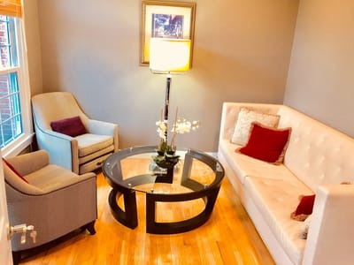 Cozy lounge area with seating and a lamp