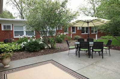 Outdoor patio area with seating and greenery