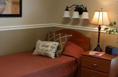 Cozy bedroom with a bed and lamp in a residential setting