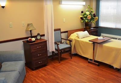 Cozy resident room with bed and seating area