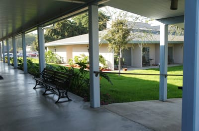 Interior corridor with seating area and view of building
