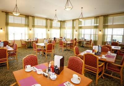 Dining area set up for meals with tables and chairs