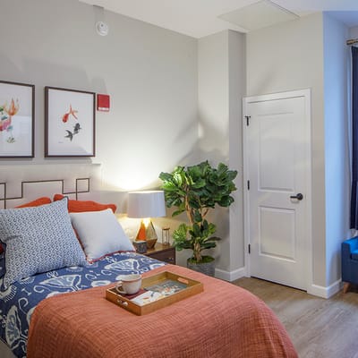 Cozy resident room with bed and artwork