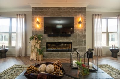 Cozy interior common area with a television and fireplace