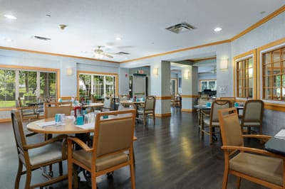 Bright dining area with tables and chairs set up
