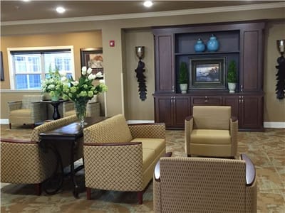 A cozy common area with seating and floral decor