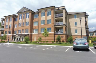 Exterior view of Kirkland Village building with parking lot