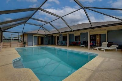Swimming pool area with screened patio