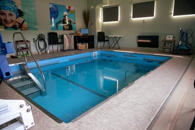 Indoor therapeutic pool area with exercise equipment