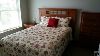 Cozy resident room with a bed and dresser