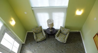 Interior lounge area with two chairs and lamp
