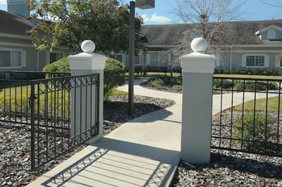 Pathway leading to the facility with garden landscaping