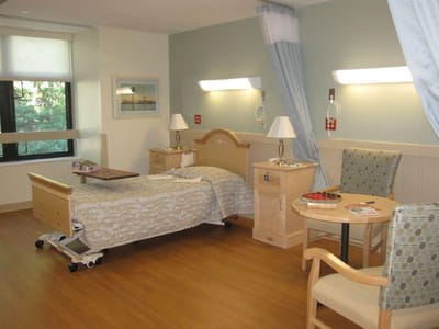 Cozy private resident room with a bed and seating area