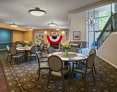 Bright dining room with tables and flowers