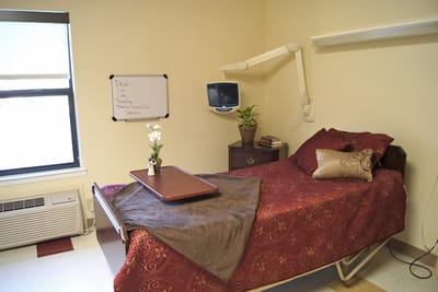 A private resident room with a hospital bed and decor