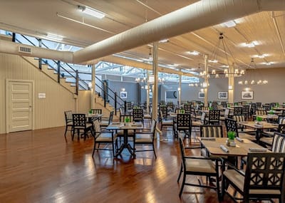Dining room with tables and chairs set up for residents