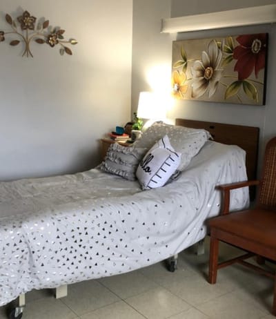 Cozy resident room with floral decor and a comfortable bed
