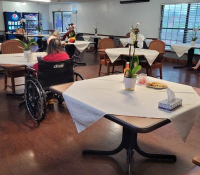 Residents dining in a common area with decor