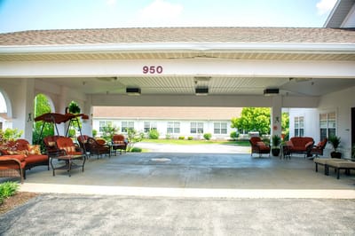 Covered outdoor seating area with plants and furniture