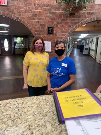 Staff members at the reception area with COVID precautions