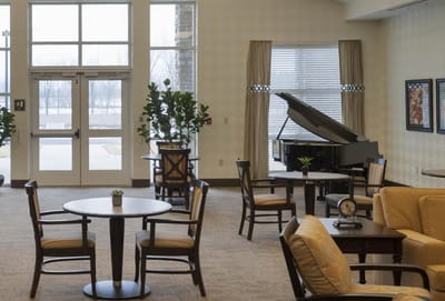 Bright common area with seating and a piano