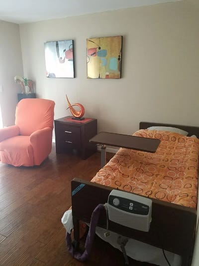 Cozy resident room with bed and armchair
