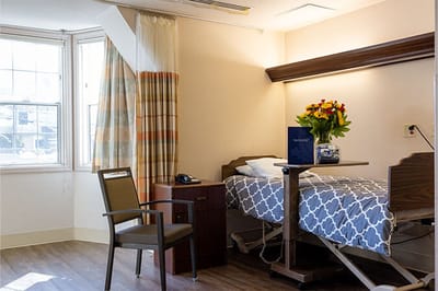 Bright resident room with a floral arrangement