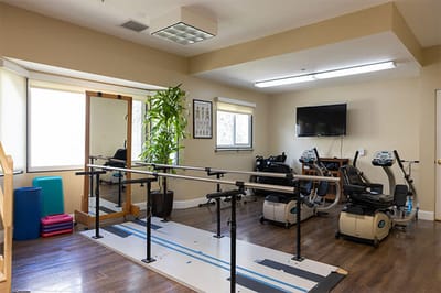 Rehabilitation room with equipment and natural light