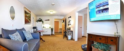 Cozy interior of a resident's room with a TV and sofa