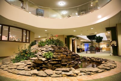 Interior view of a serene common area with a water feature