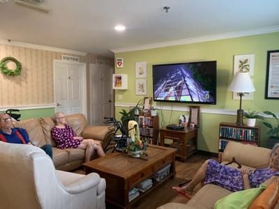 Residents relaxing in a common area watching TV