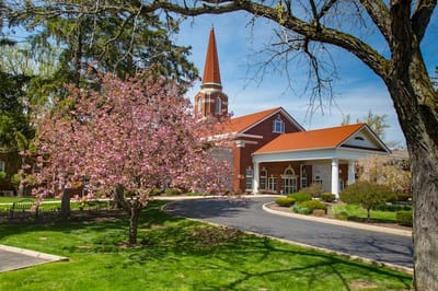 Exterior view of Peabody Retirement Community with blooming trees
