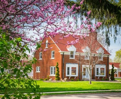 Exterior view of a charming brick retirement community building