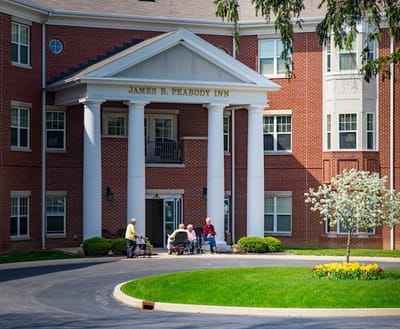 Residents socializing in front of the facility entrance