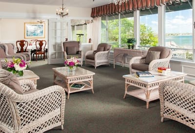 Bright common area with wicker furniture and ocean view