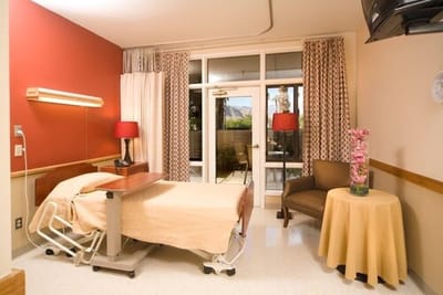 Private resident room with a bed and seating area