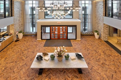 Bright and welcoming lobby with a chandelier and floral decor