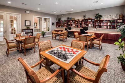 Common area with checkerboard tables and bookshelves