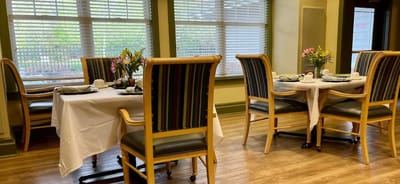 Dining area set for a meal with floral centerpieces
