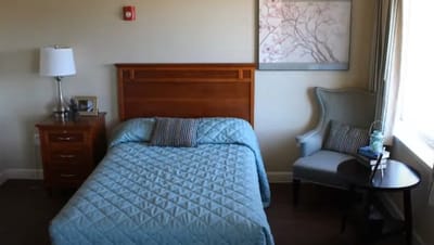 Cozy resident room with a bed and armchair