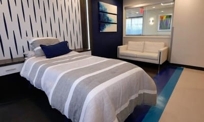 Private resident room with a cozy bed and seating area