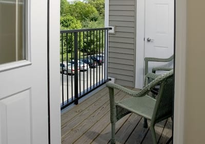 Interior balcony with chairs overlooking a parking lot