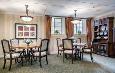 Bright and inviting common area with dining tables