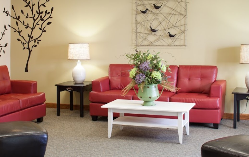 Interior lounge area with red seating and decorative flowers