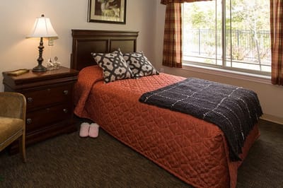 Cozy resident room with bed and window view