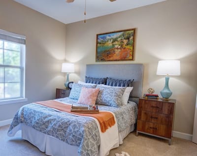 Cozy resident room with bed and artwork